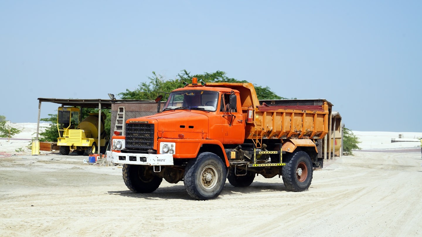 Orange dump truck on a work site