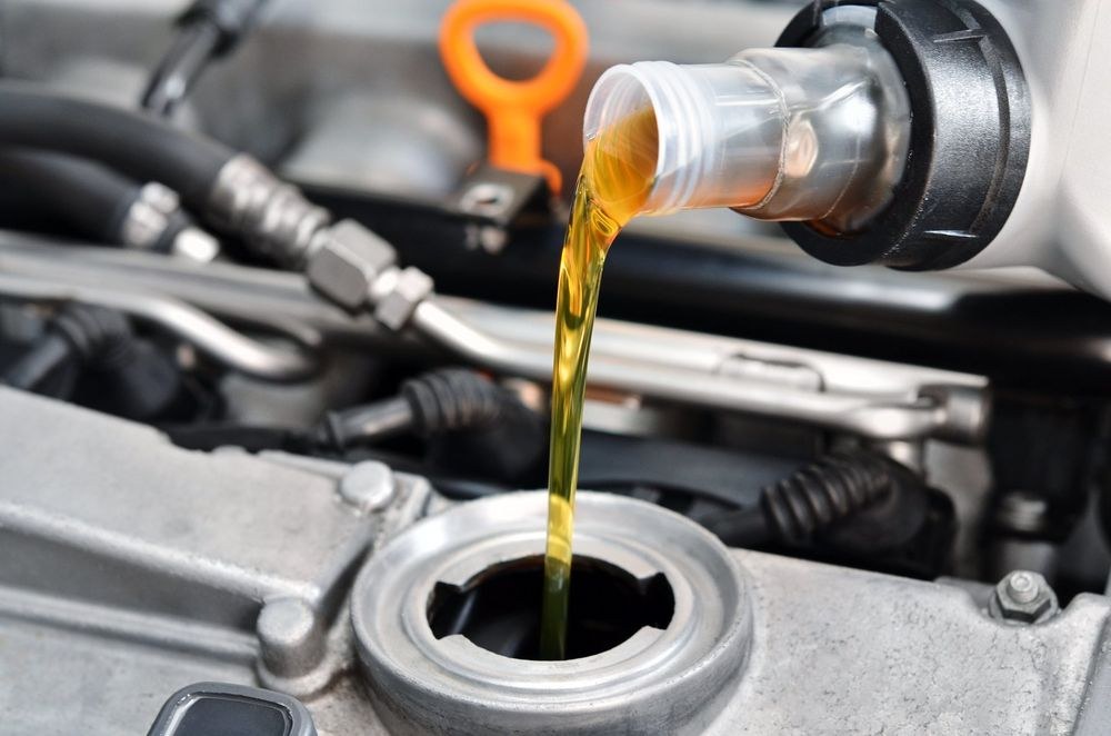 Oil being poured into an engine during maintenance