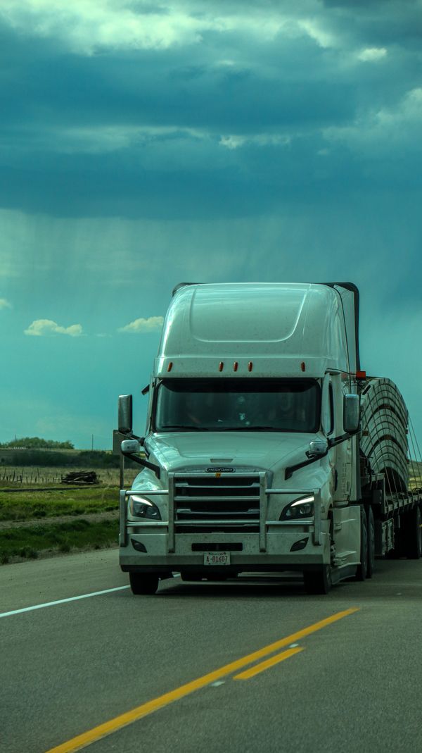 White semi-truck driving on the highway